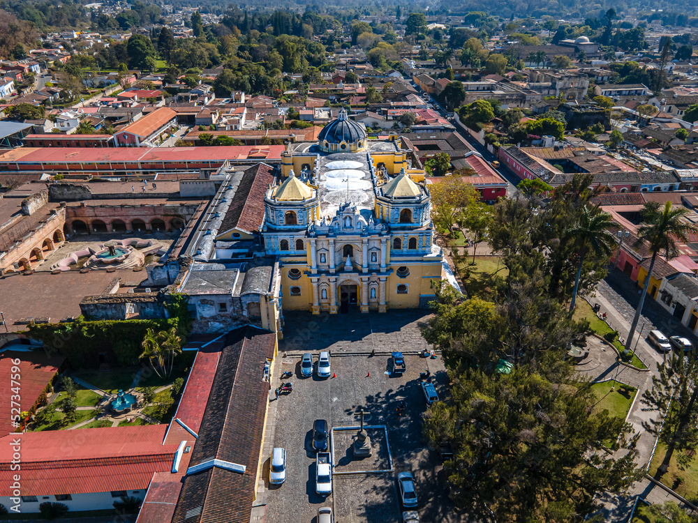 Beautiful aerial cinematic footage of the Antigua City in Guatemala, Its yellow church, the Santa Catalina Arch and the Acatenango Volcano