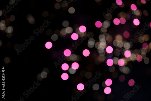 On a black background bokeh from explosions of colorful fireworks.