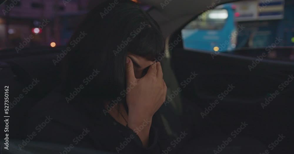 Upset young woman covering face with shame while riding taxi cab in the backseat of car. One anxious hispanic girl feeling overwhelmed by modern pressure. Upset young woman covering face with shame while riding taxi cab in the backseat of car. One anxious hispanic girl feeling overwhelmed by modern pressure.