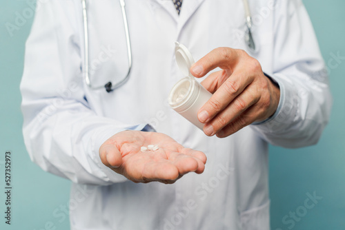 Doctor pouring pills on his palm