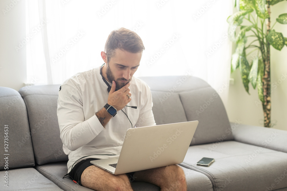 Young man freelancer using laptop studying online working from home, happy casual guy typing on notebook. Young man freelancer using laptop studying online working from home, happy casual guy typing on notebook.