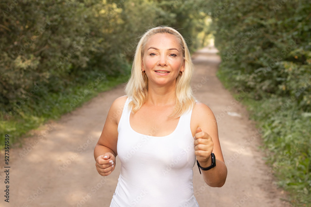young beautiful girl jogging in the woods on a hot summer day Healthy lifestyle young beautiful girl jogging in the woods on a hot summer day Healthy lifestyle