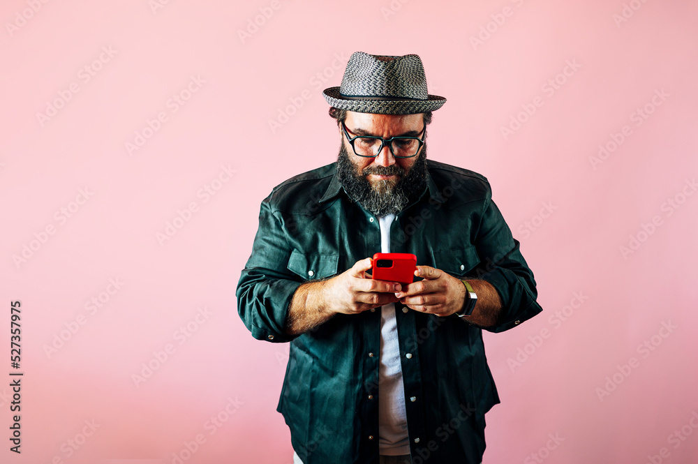 Bearded fat man using smartphone. Bearded fat man using smartphone.