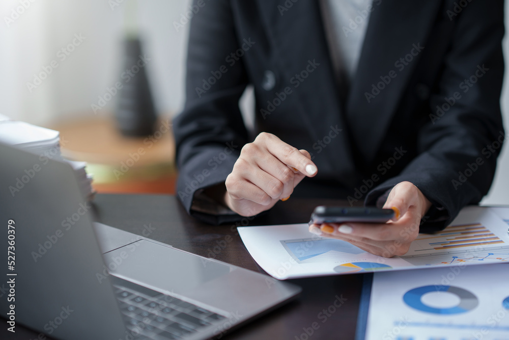 Close-up of a woman using a smartphone to work on various application including mobile transaction to send messages, LINE, and various business information sent via social media. Close-up of a woman using a smartphone to work on various application including mobile transaction to send messages, LINE, and various business information sent via social media.