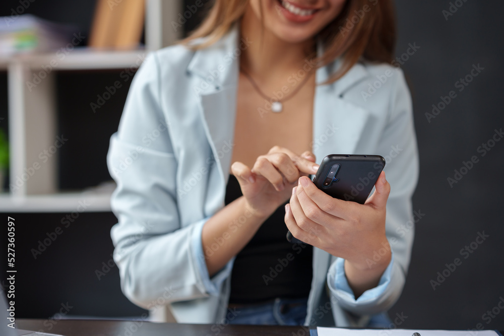 Close-up of a woman using a smartphone to work on various application including mobile transaction to send messages, LINE, and various business information sent via social media. Close-up of a woman using a smartphone to work on various application including mobile transaction to send messages, LINE, and various business information sent via social media.