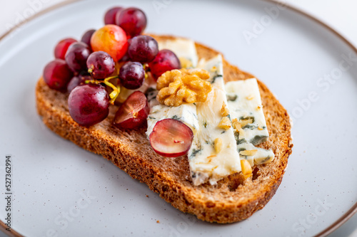 Wallpaper Mural Toasted bread with mild creamy blue cheese, grapes and walnuts on grey plate Torontodigital.ca