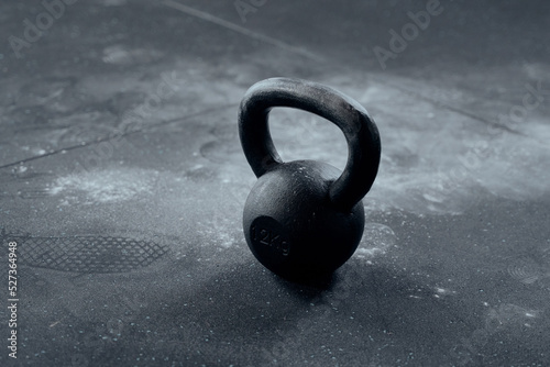 Close-up of kettlebell with chalk around at the gym