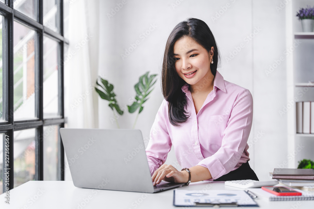 Smiling Asian businesswoman working on laptop in modern office Accountant Concept Finance Expert Analyze Business Report Graph financial chart financial chart corporate economy Banking Market Research Smiling Asian businesswoman working on laptop in modern office Accountant Concept Finance Expert Analyze Business Report Graph financial chart financial chart corporate economy Banking Market Research