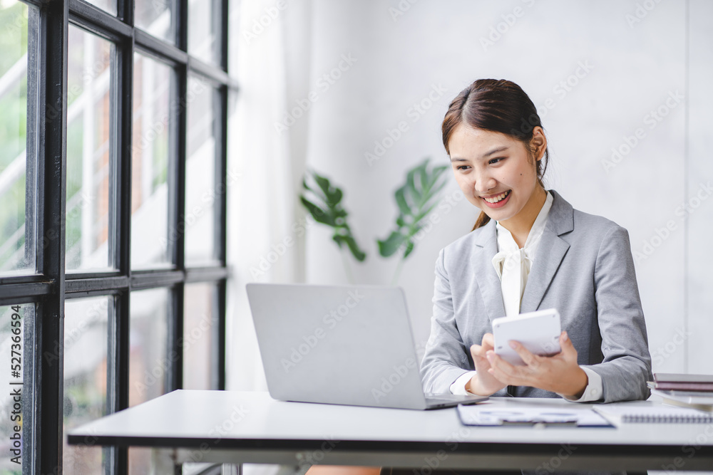 Smiling Asian businesswoman working on laptop in modern office Accountant Concept Finance Expert Analyze Business Report Graph financial chart financial chart corporate economy Banking Market Research Smiling Asian businesswoman working on laptop in modern office Accountant Concept Finance Expert Analyze Business Report Graph financial chart financial chart corporate economy Banking Market Research