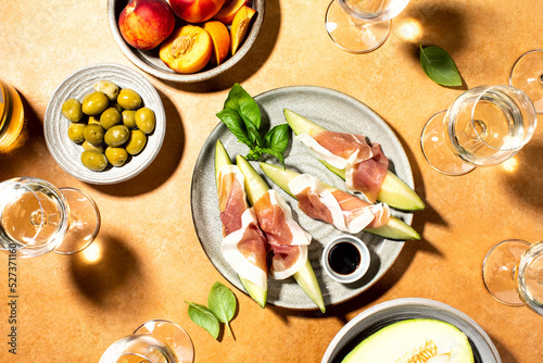 Melon with prosciutto served with white wine