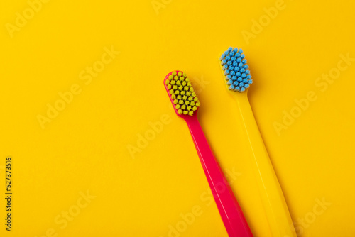 Oral care. Bright toothbrushes on yellow paper. Dentist concept. Flat lay. copy space.Place for text © Avocado_studio