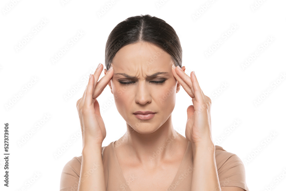 Beautiful young woman with strong headache on a white background. Beautiful young woman with strong headache on a white background.