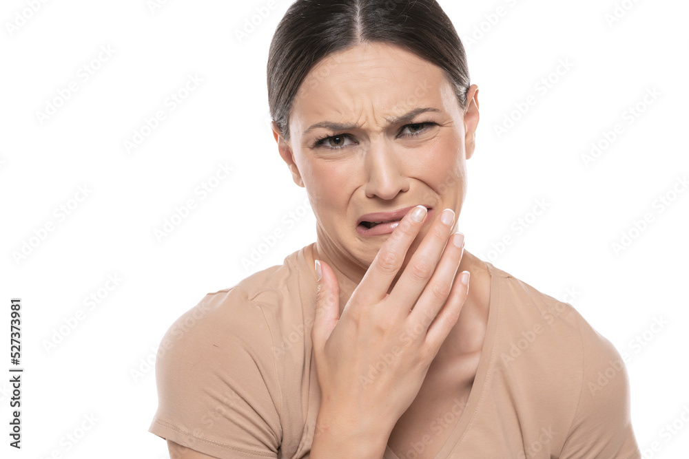 disgusted and frowning young woman on a white background disgusted and frowning young woman on a white background