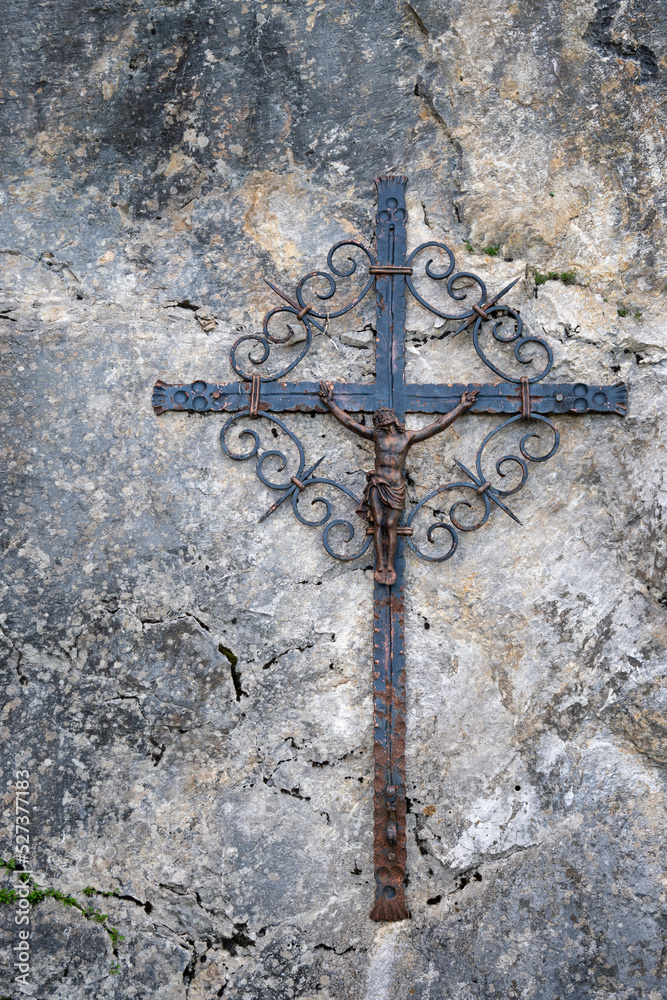 Ancient old religious cross with Jesus Christ on wall