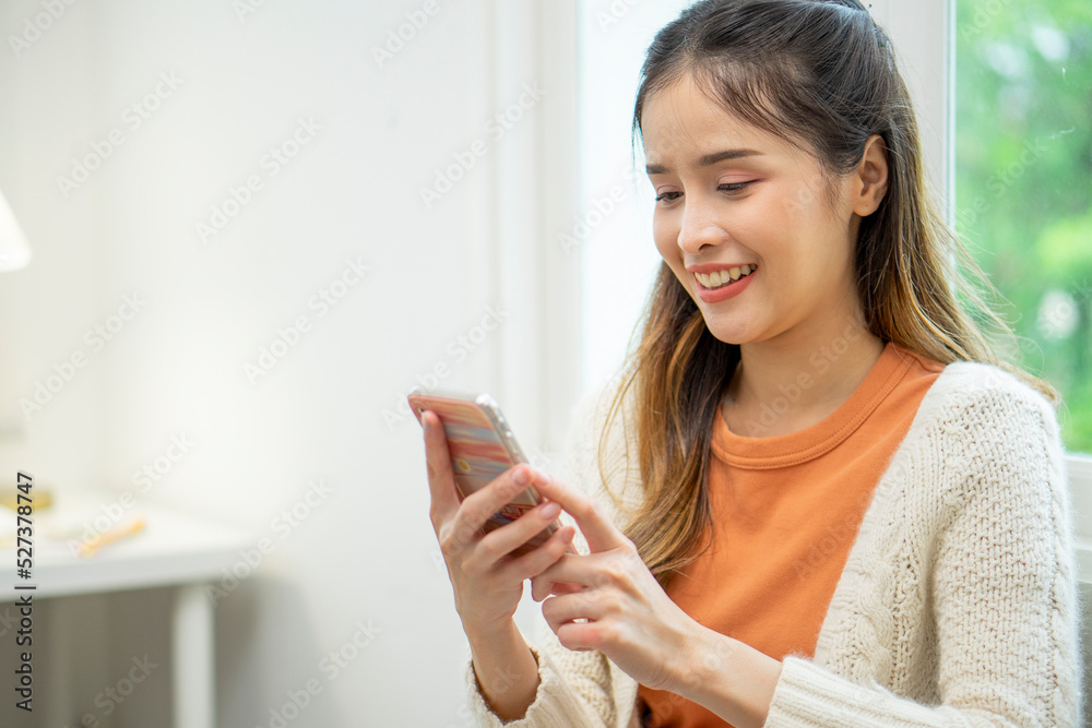 Asian woman using a smartphone to play social media. Asian woman using a smartphone to play social media.