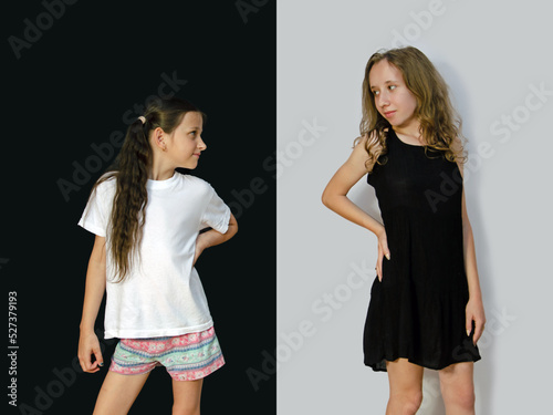 Portrait of two smiling young girls looking at each other on a black and white background