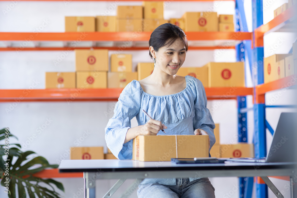 Young Asian woman entrepreneur SME Startup small Business owner working at home for online shopping and preparing package product deliver to customers, Asian Online SME business entrepreneurs ideas, Young Asian woman entrepreneur SME Startup small Business owner working at home for online shopping and preparing package product deliver to customers, Asian Online SME business entrepreneurs ideas,
