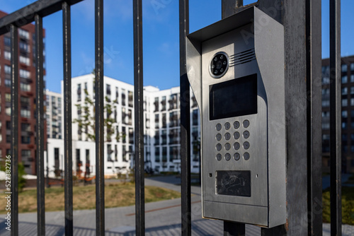 Electronic lock with buttons and intercom on the metal fence gate, safety device.