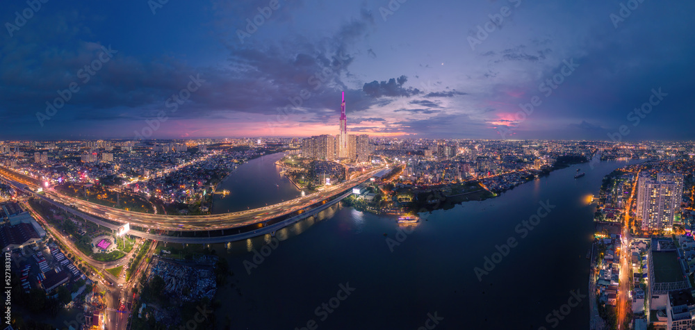 Aerial sunset view at Landmark 81 - it is a super tall skyscraper and Saigon bridge with development buildings along Saigon river light smooth down, Saigon skyline