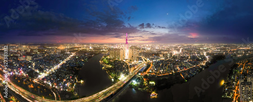 Aerial sunset view at Landmark 81 - it is a super tall skyscraper and Saigon bridge with development buildings along Saigon river light smooth down, Saigon skyline photo