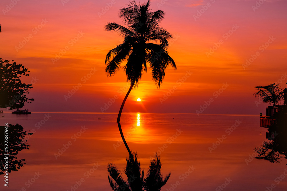 Sunset on Maldives island. Beautiful sky and ocean and beach with palms background for summer vacation holiday and travel concept.
