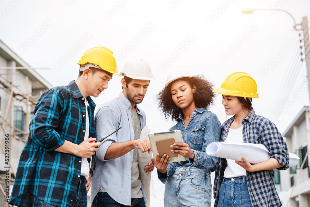 The conversation taking place on the construction site between an architect, an engineer, and a tablet computer displaying a building draft design. The conversation taking place on the construction site between an architect, an engineer, and a tablet computer displaying a building draft design.