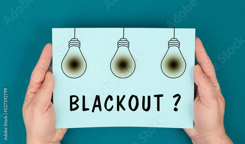 The word blackout is standing under the blown lightbulbs, power cut out, uncertain energy supply
 photo