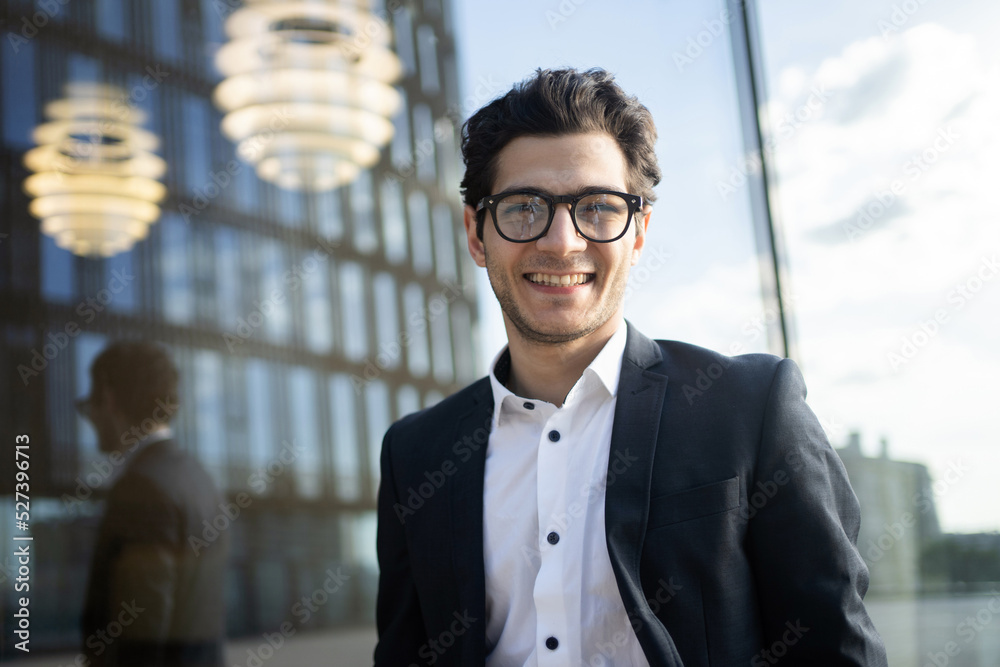 A business manager in a business suit happily goes to a new job in the office A business manager in a business suit happily goes to a new job in the office