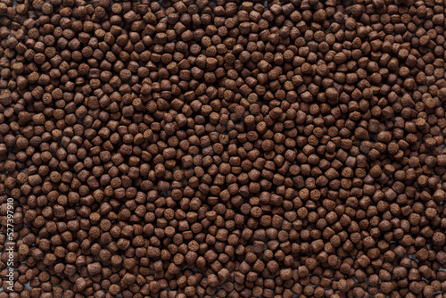 Animal feed mixed from finely ground protein powders of both plants and animals is pelleted to be used as pet food because pellets are convenient and accurate in feeding quantity.Copy Space background