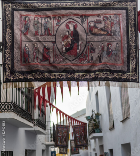 Banner of the Virgin with the Romanesque baby Jesus hanging in a street in Frigiliana on the occasion of the Festival of the three cultures photo
