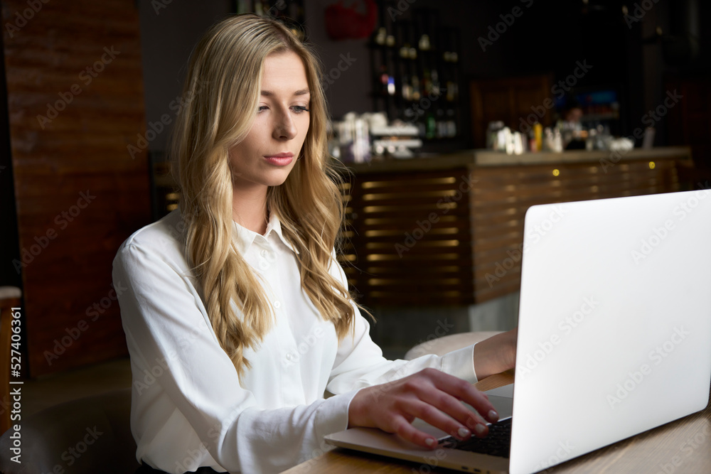 Business woman using computer at workplace in modern cafe. Working for pleasure and success. Office worker doing task remotely. Business woman using computer at workplace in modern cafe. Working for pleasure and success. Office worker doing task remotely.