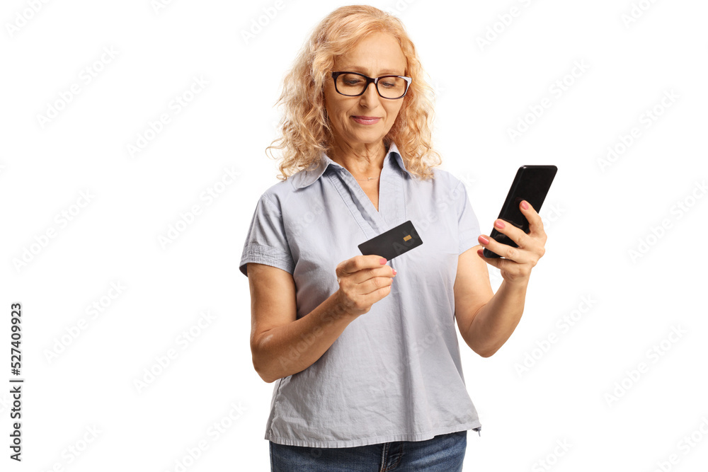 Woman using a smartphone and paying with a credit card Woman using a smartphone and paying with a credit card
