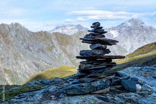 A cairn (also called stone man or stone mandl) in the Austrian Alps used as a trekking path sign.