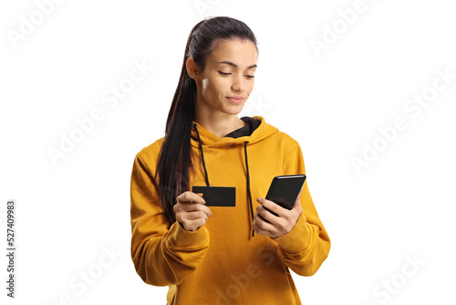 Young woman shopping online with a credit card and a smartphone