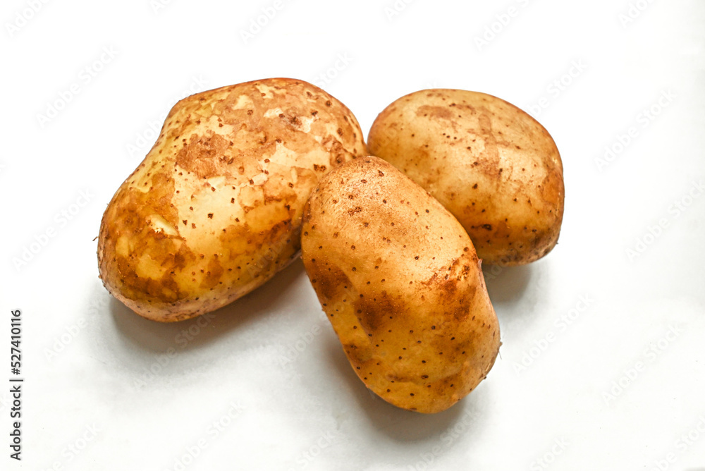 young potatoes with hard shadows on a white background young potatoes with hard shadows on a white background