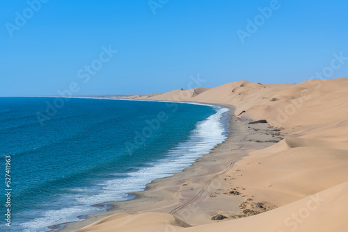Fototapeta Naklejka Na Ścianę i Meble -  Namibia, the Namib desert, landscape of yellow dunes falling into the sea
