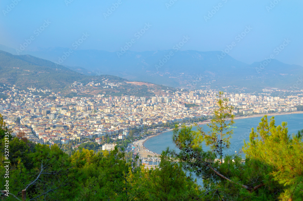 View to the sea coast line of Alanya city, Turkey, resort area in summer time under the blue sky, blue waters