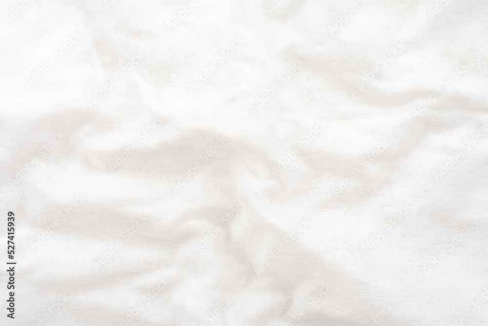 A twisted piece of white fabric. White material or texture with waves and folds. Wrinkled white fabric A twisted piece of white fabric. White material or texture with waves and folds. Wrinkled white fabric
