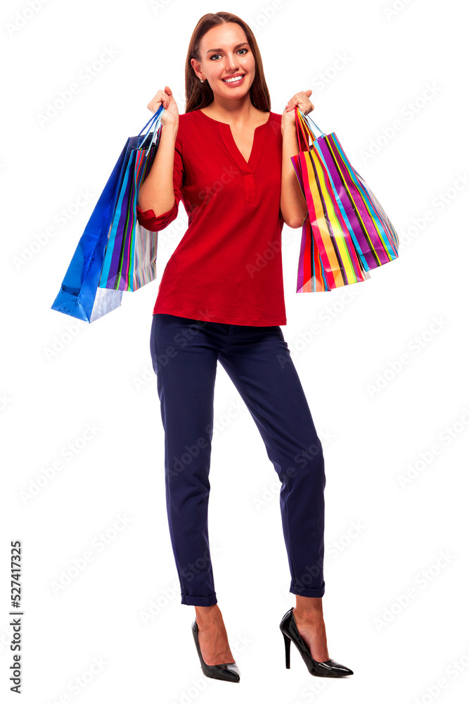 Portrait of young happy smiling pretty woman with shopping bags, isolated over white background.