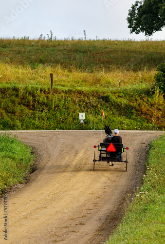 Amish woman riding a horse and cart on a back road in Holmes County  Ohio