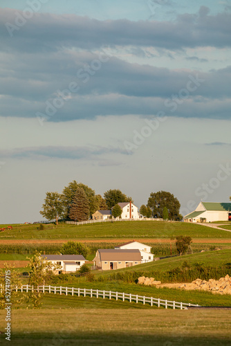 Amish farms situated among the rolling hills of Amish country, Ohio, on a late summer afternoon under a cloudy sky