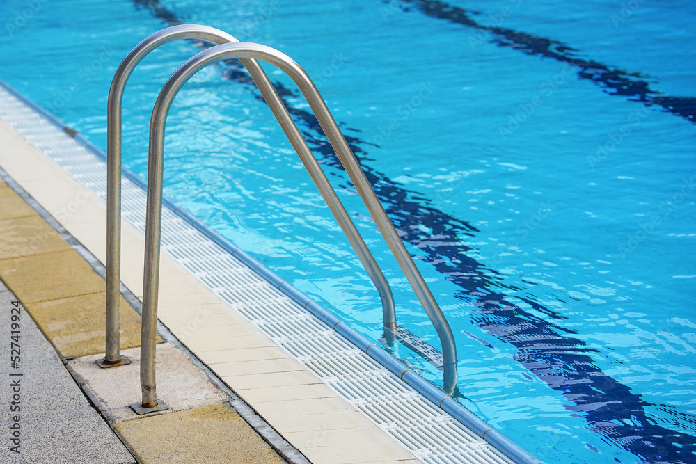 Handrails for descent into the pool. Pool cleaner during his work Handrails for descent into the pool. Pool cleaner during his work