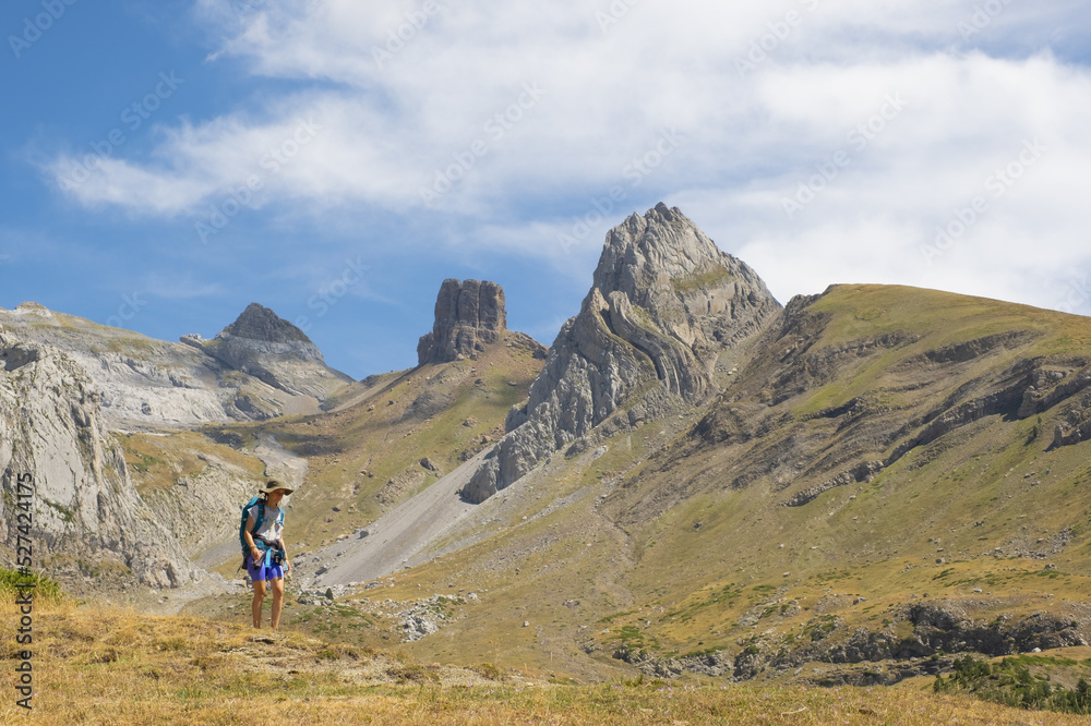 Girl hiker in the Ig?er circus with the Riguelo peak in the background, Western Valleys Natural Park, Huesca.