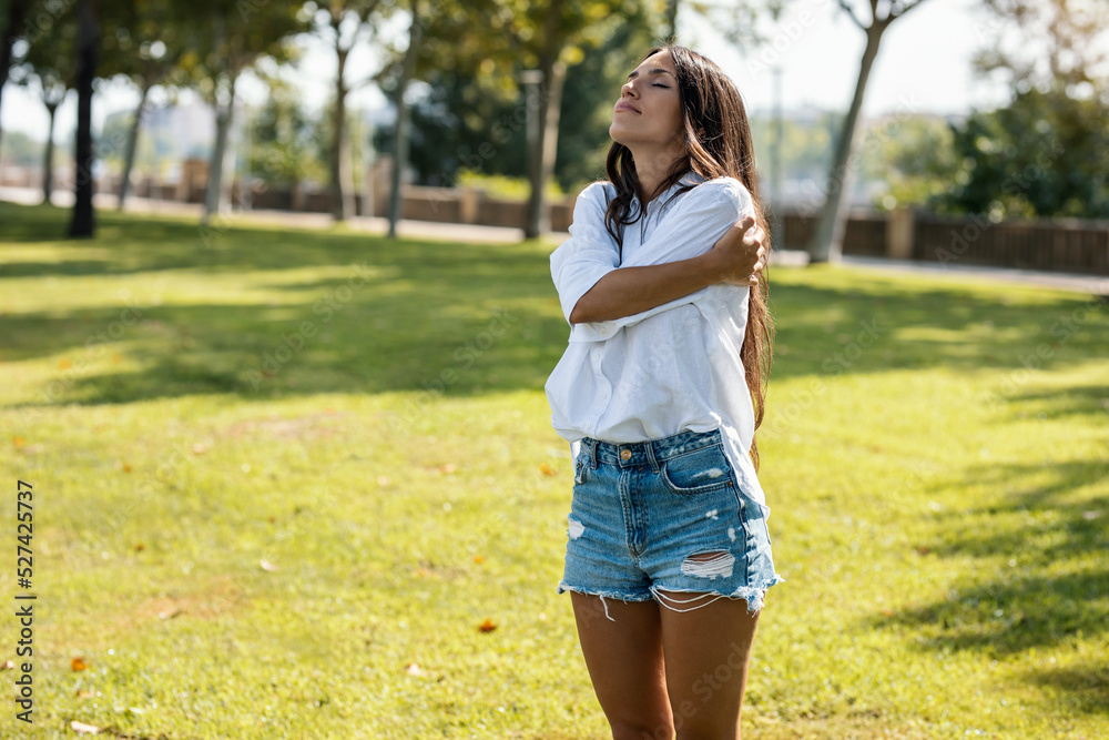 Beautiful young woman doing yoga and meditation in a park. Beautiful young woman doing yoga and meditation in a park.