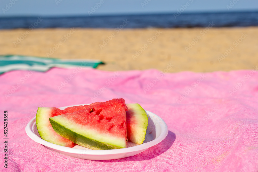 Fresh ripe slices of watermelon, isolated sea background, vacation on the beach Fresh ripe slices of watermelon, isolated sea background, vacation on the beach