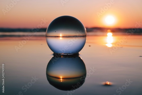 Valokuvatapetti Close-up Of Crystal Ball At Sea During Sunrise