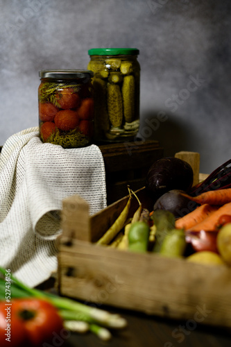 Fototapeta Naklejka Na Ścianę i Meble -  Glass jars with pickled cucumbers and tomatoes