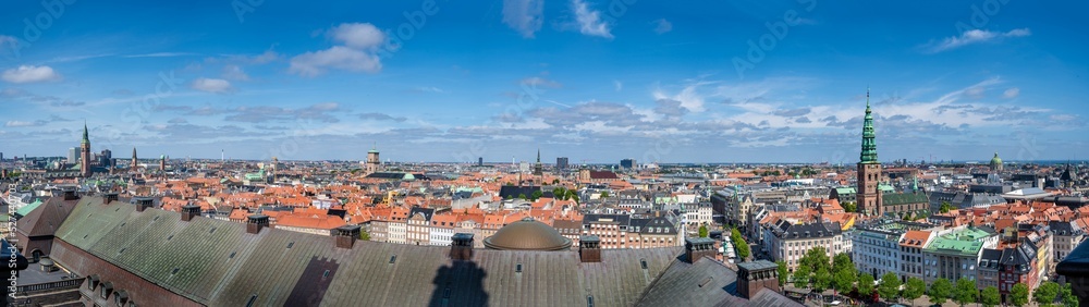 Panorama view Copenhagen, Denmark skyline from Christiansborg Palace tower. Aerial view of roofs and cityscape on a sunny day with the towers of  the most important sightseeing spots