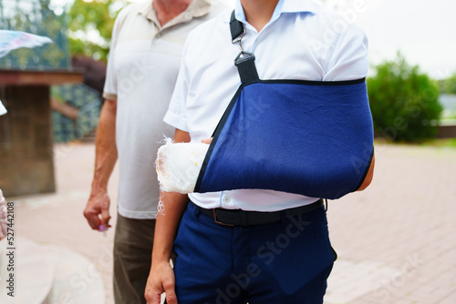 a man with a broken arm in a cast. treatment of limb fractures.