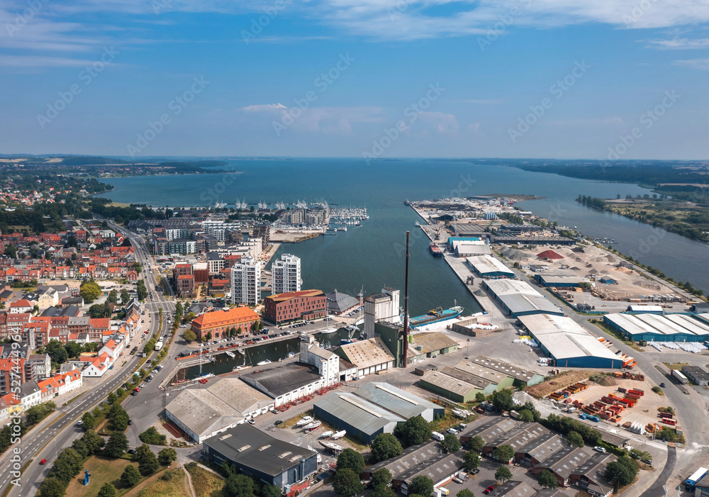 Summer cityscape of Horsens, Jutland, Denmark. Aerial panorama of the industrial area around Horsens Havn (harbor) and the Fjord in the background